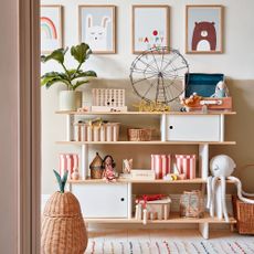 Kids bedroom with open shelving storage with toys and baskets 