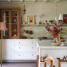 kitchen with neutral white walls and cabinetry and island with dark wood flooring and unpainted wooden unit cabinets
