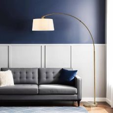 A modern lounge with a curved floor lamp from Pagazzi.