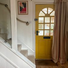 Internal hallway with staircase and yellow front door