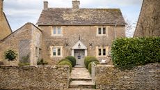 exterior of a Cotswold stone cottage with decorative porch
