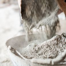 Pouring plaster into a bucket ready for mixing with water