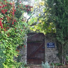 rustic wooden garden gate in a stone wall