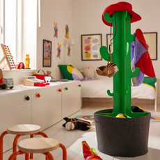 IKEA cactus coat stand in a white childrens bedroom with red accents.