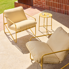 Yellow Tuscany birstro set positoned on a sunny patio.